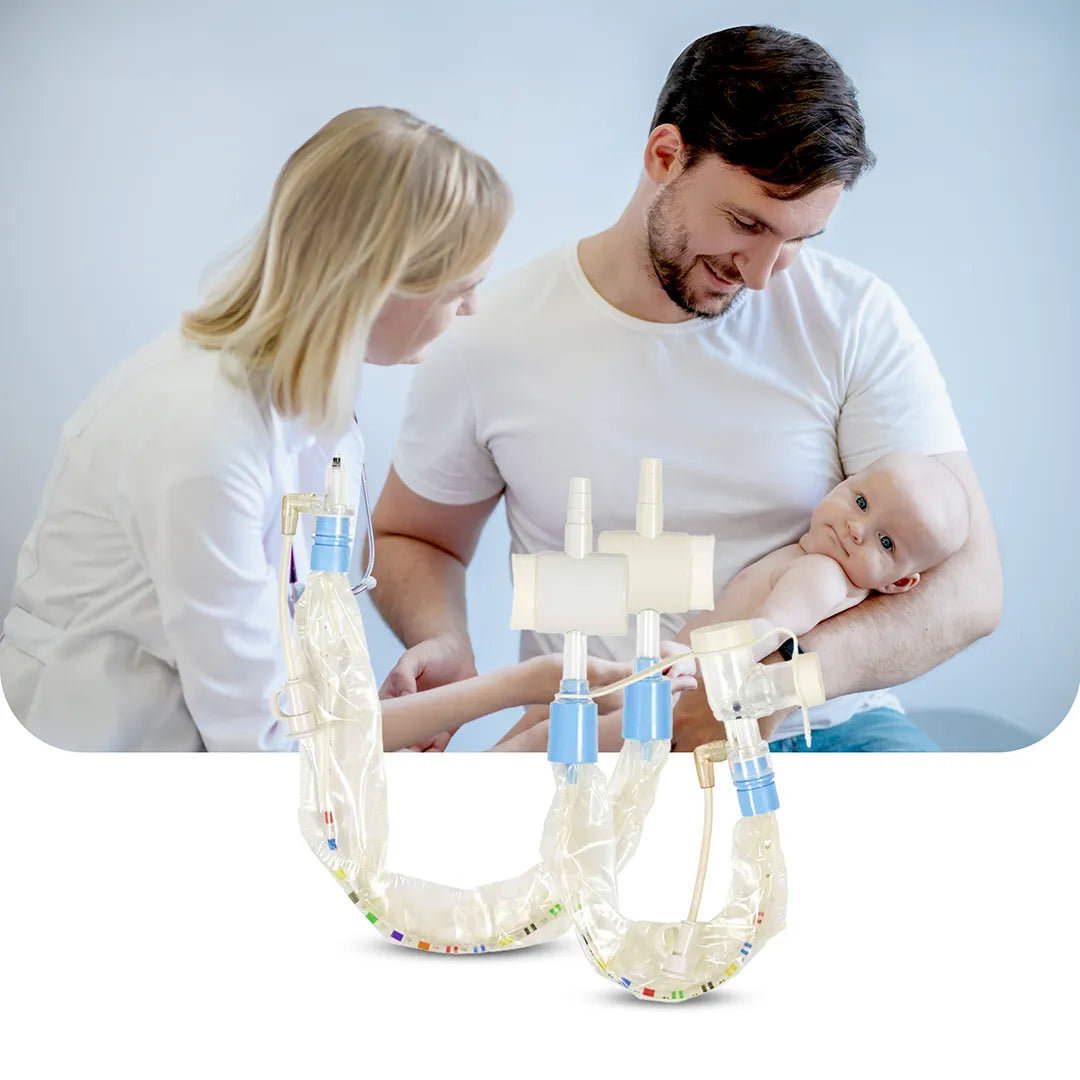 A nurse and father caring for a baby, with AVANOS BALLARD neonatal closed suction systems featuring Y and elbow adapters displayed in the foreground.