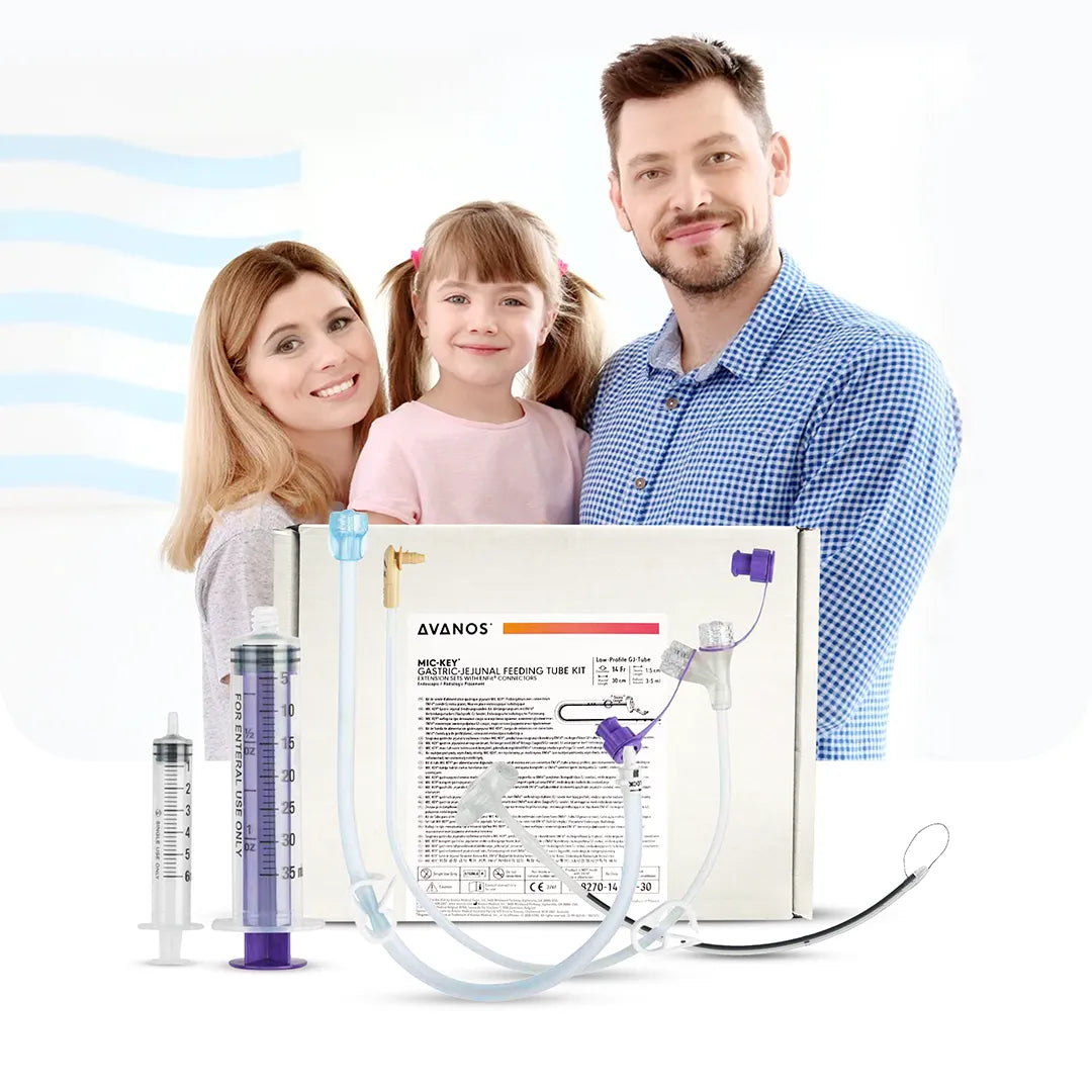 Smiling family with Avanos MIC-KEY Gastric-Jejunal Feeding Tube Kit in foreground, showing ENFit-compatible GJ tube components, available at Medisa.