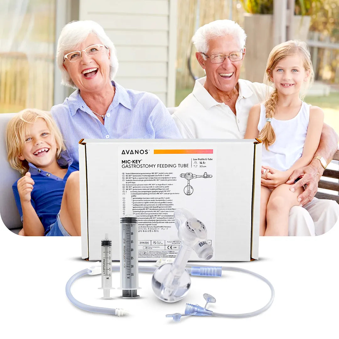Happy family sitting together with Avanos MIC-KEY Gastrostomy Feeding Tube kit in foreground, including ENFit-compatible accessories, available at Medisa.