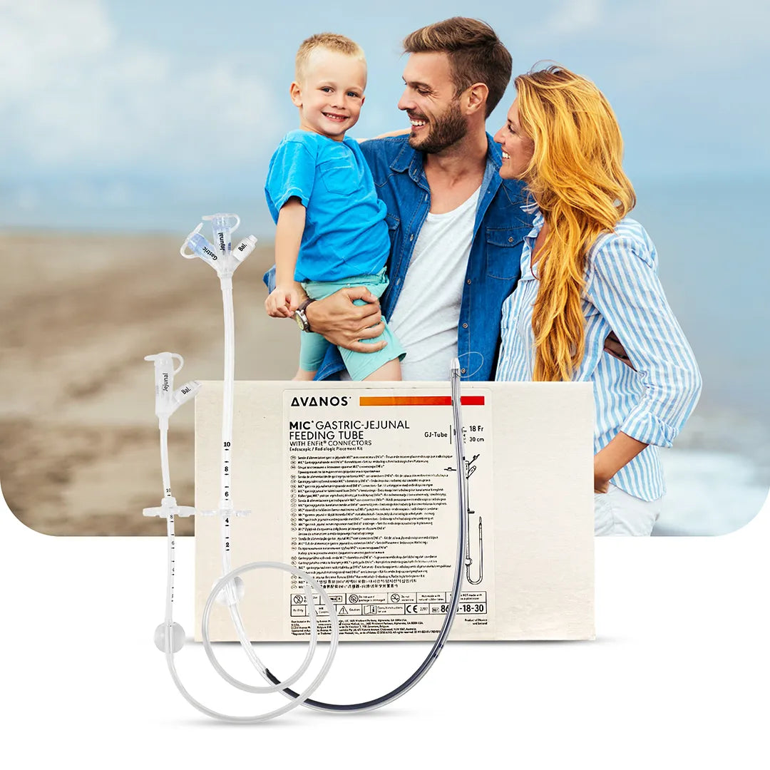 Happy family on beach with Avanos MIC Gastric-Jejunal Feeding Tube kit in foreground, showing ENFit-compatible dual-port GJ tube, available at Medisa.