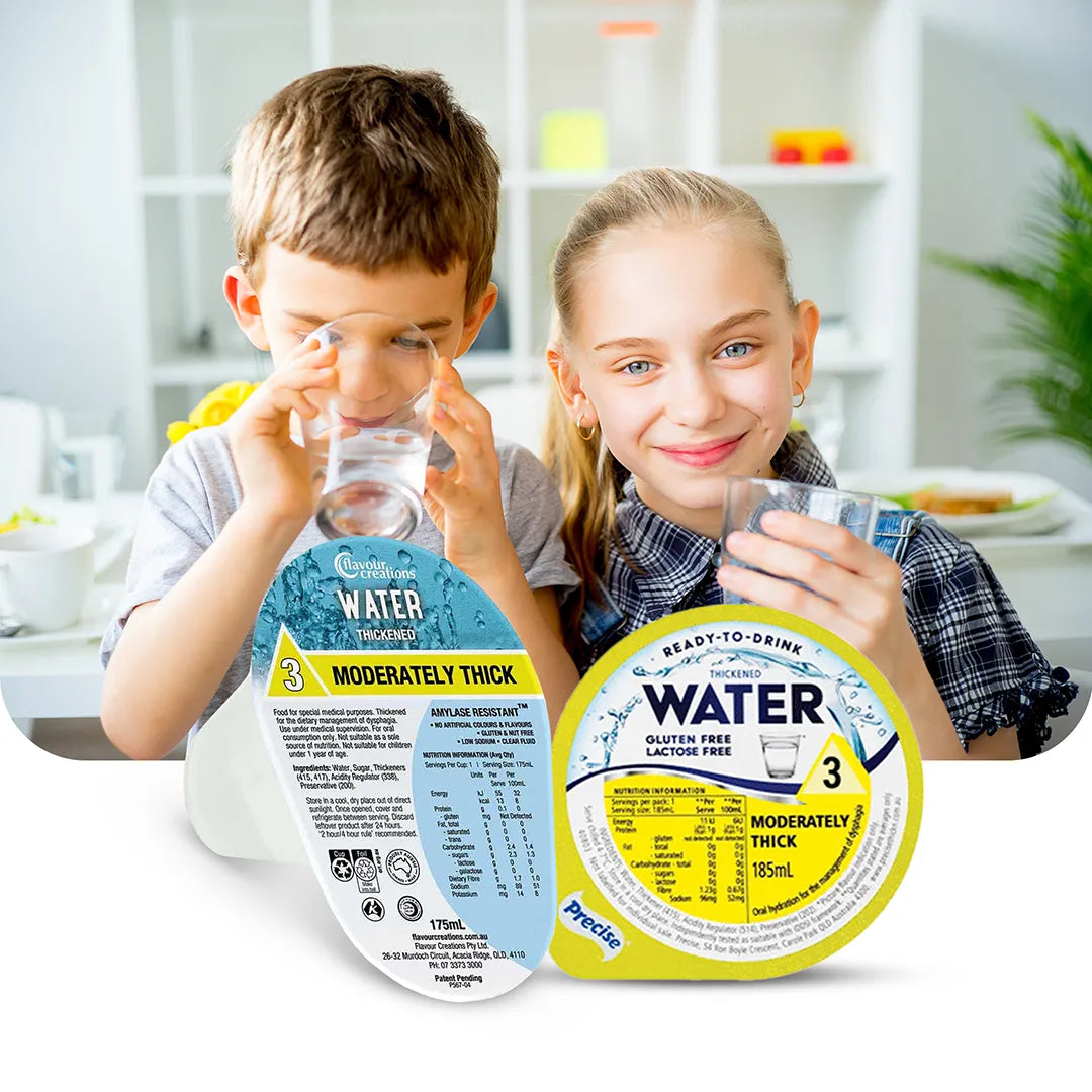 Two smiling children drinking thickened water, with Flavour Creations and Precise moderately thick ready-to-drink hydration cups in the foreground, designed for individuals with dysphagia.